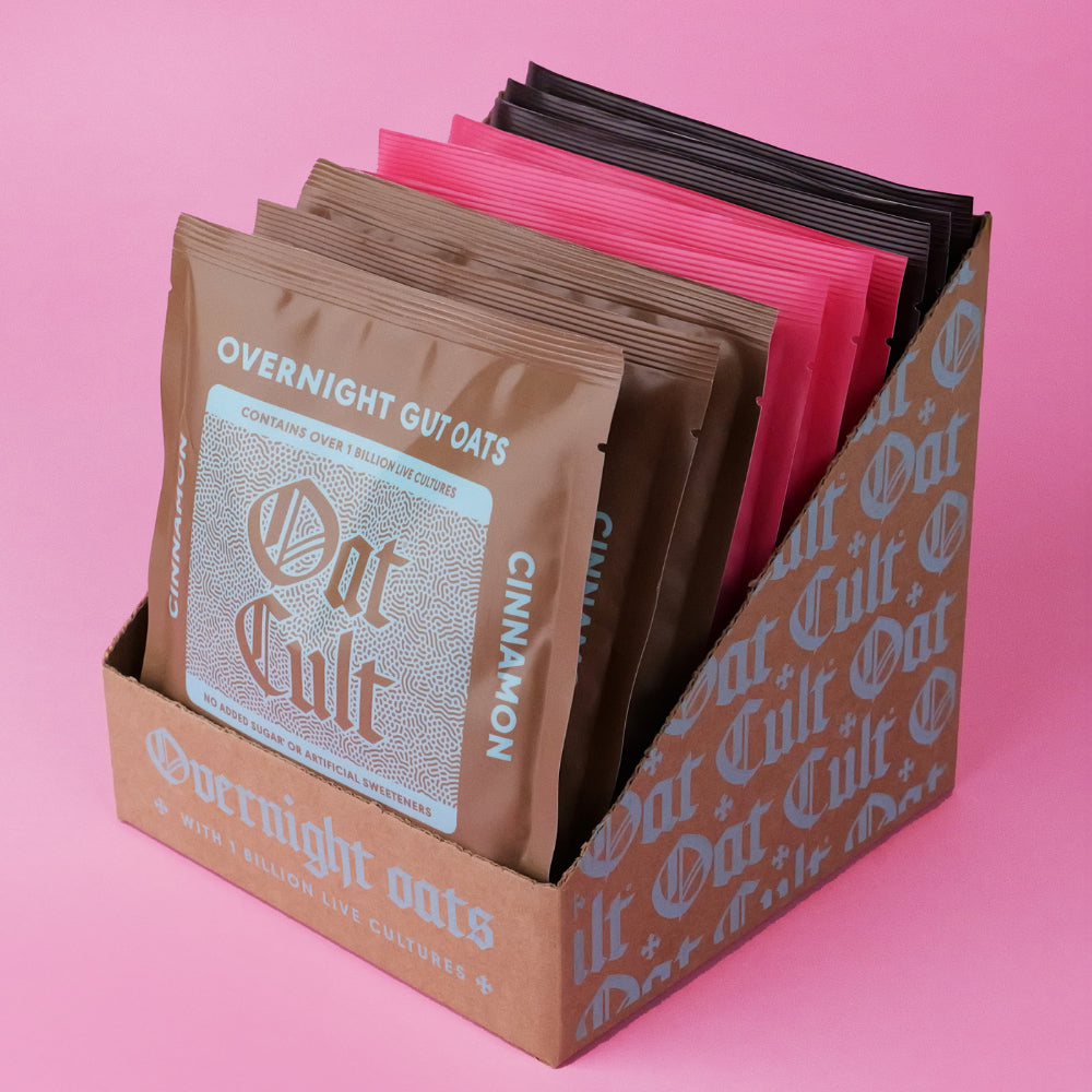 Box of Oat Cult overnight oats mixed p pack on a pink background